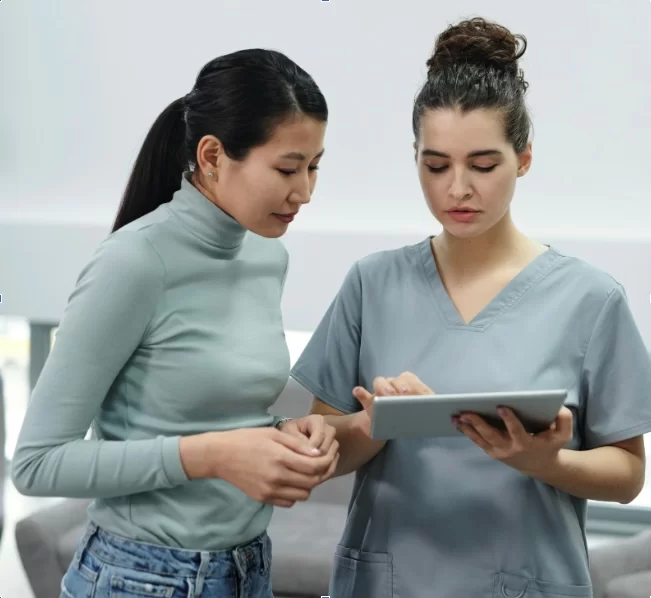 Nurse And Patient Looking At Tablet Nurse And Patient Looking At Tablet