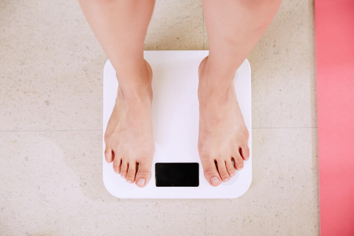 A person standing on a white scale